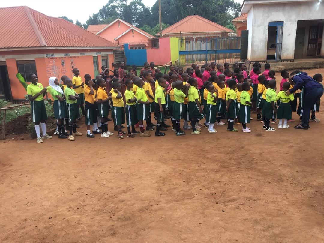A line of pupils outside the school block